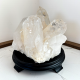 Large Clear Quartz Crystal on Black Wooden Stand